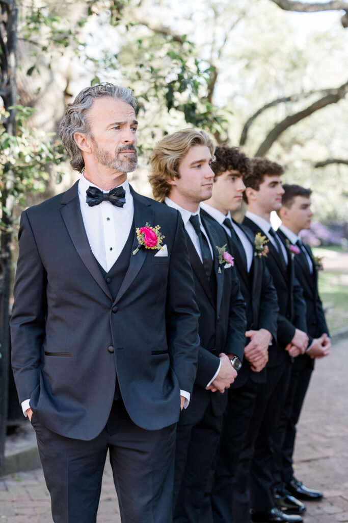 Father with 4 sons in black tuxes celebrating a wedding anniversary in Charleston