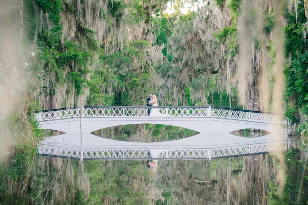 Magnolia Plantation white bridge with wedding couple at the end of a wedding photography timeline for sunset portraits