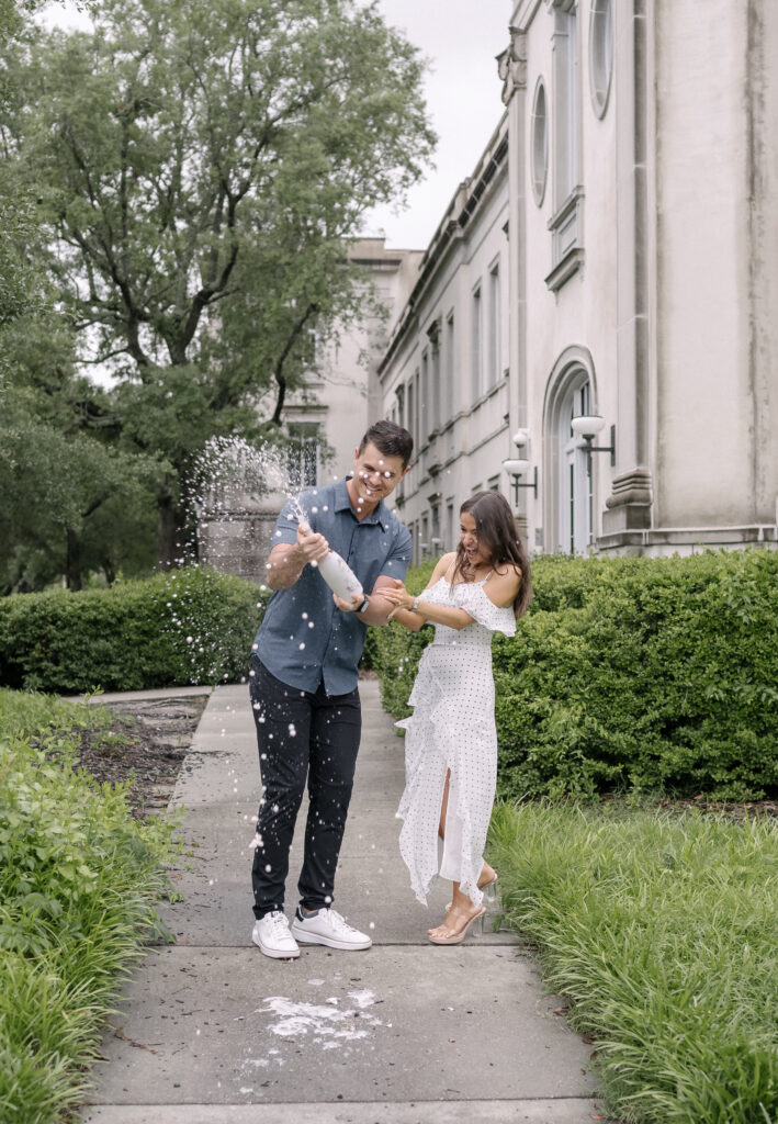Engaged Couple Popping Champagne in downtown Charleston