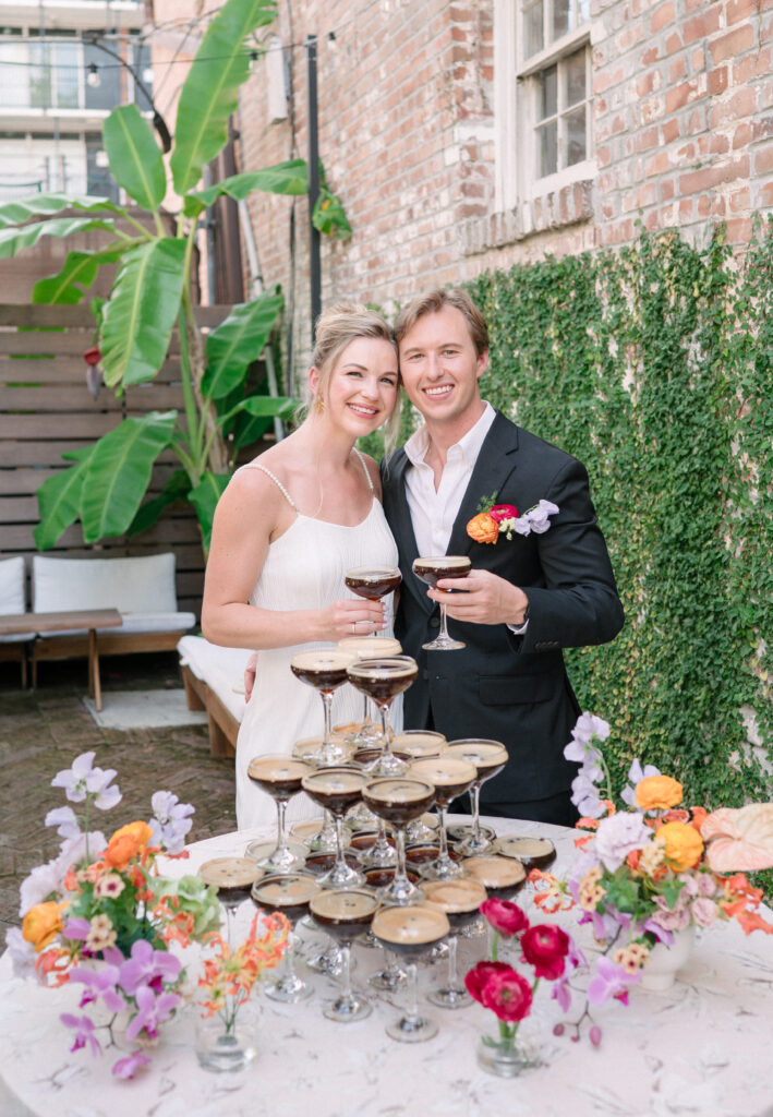 Bride and Groom with Espresso martini champagne tower at Charleston micro wedding reception at Mudhouse Coffee