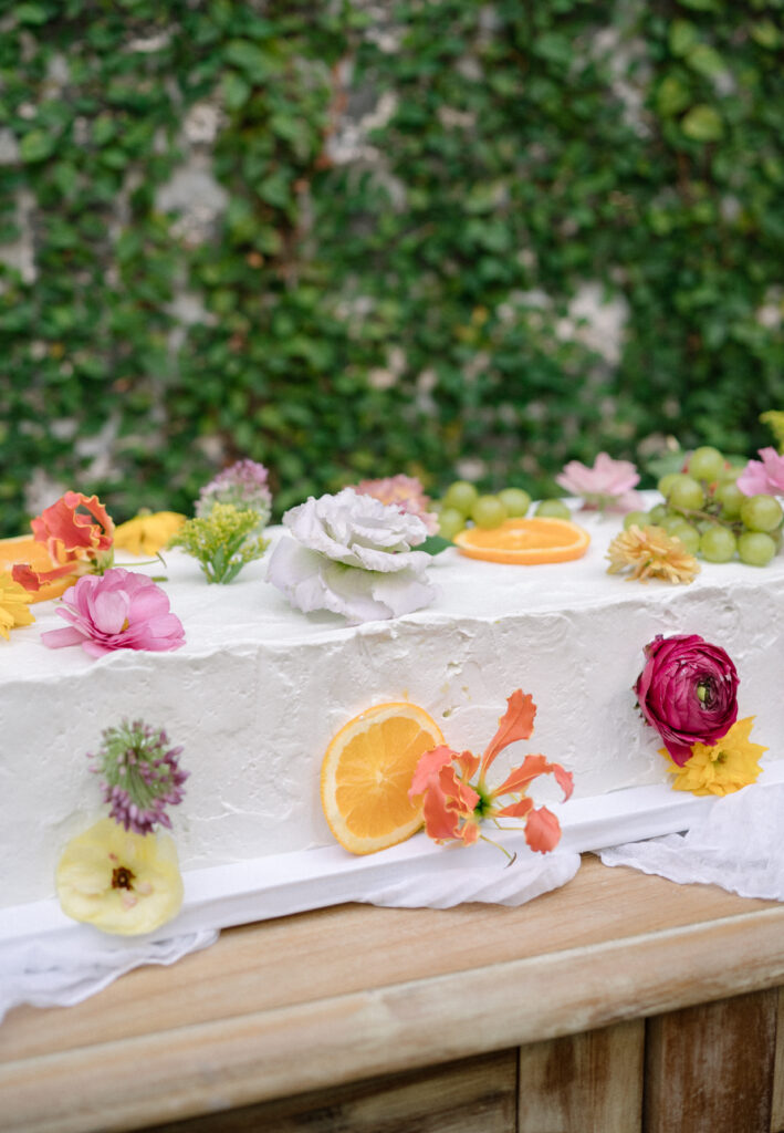 Long rectangular wedding cake with fruit and floral details by Rise Bespoke Bakery in Charleston