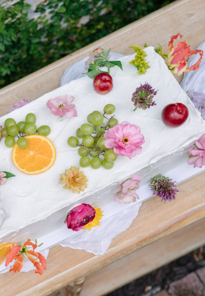 Long rectangular wedding cake with fruit and floral details by Rise Bespoke Bakery in Charleston